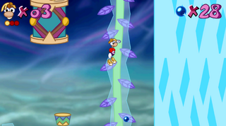 Rayman hanging on a frosty vine in the third level of Gourmand Band.
